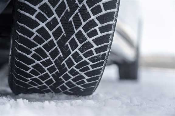 Close up of snow tire in the snow
